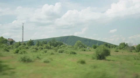 View from window of high-speed train on landscape of beautiful nature wild field Stock Footage 157698220
