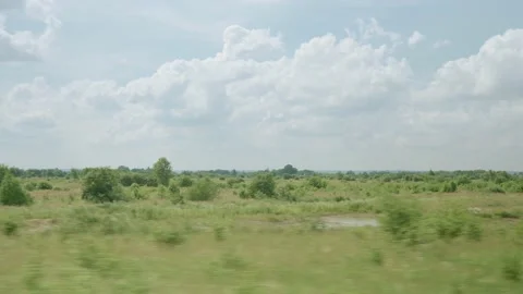 View from window of high-speed train on landscape of beautiful nature wild field Stock Footage 157836510