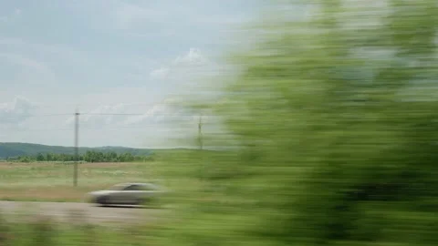 View from window of high-speed train on landscape of beautiful nature wild field Stock Footage 157889420