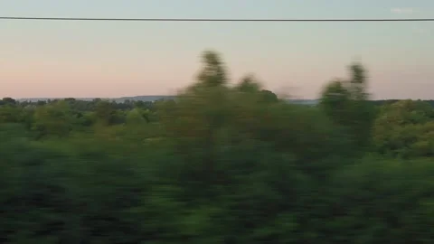 View from window of high-speed train on landscape of beautiful nature wild field Stock Footage 161600721