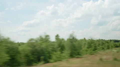 View from window of high-speed train on landscape of beautiful nature wild field Stock Footage 167482651