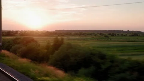 View from window of high-speed train on landscape of beautiful nature wild field Stock Footage 167482662
