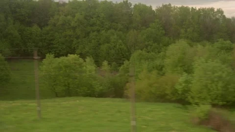View from window of high-speed train on landscape of beautiful nature field road Stock Footage 203839333