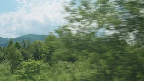 View from window of high-speed train on landscape of beautiful nature wild field Stock Footage 210269846