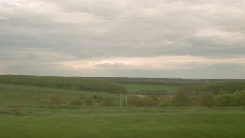 View from window of high-speed train on landscape of beautiful nature field road Stock Footage 214117139
