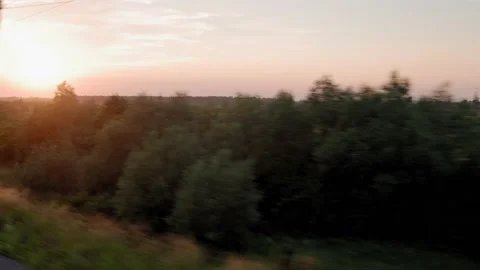 View from window of high-speed train on landscape of beautiful nature wild field Stock Footage 221549609