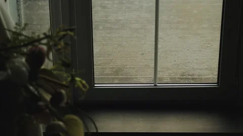 View from the window inside the house, where raindrops fall on the wooden Stock Footage 315887942