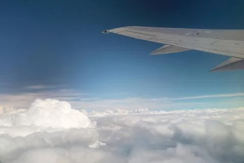 View from window of a jet plane wing with beautiful weather Stock Photos