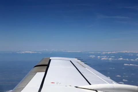 View from window of a jet plane wing with beautiful weather Stock Photos