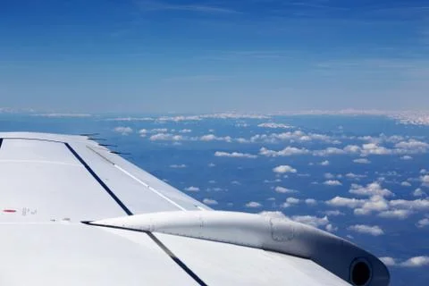 View from window of a jet plane wing with beautiful weather Stock Photos