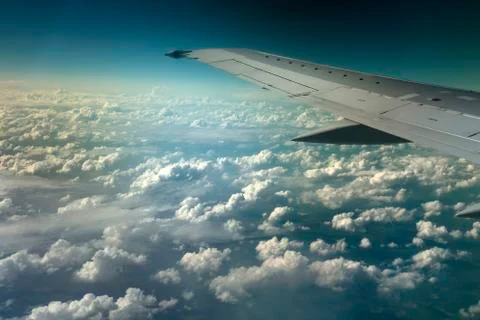 View from window of a jet plane wing with beautiful weather Stock Photos