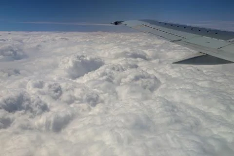 View from window of a jet plane wing with beautiful weather Stock Photos