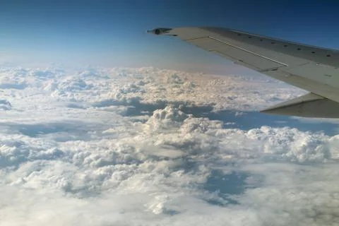 View from window of a jet plane wing with beautiful weather Stock Photos