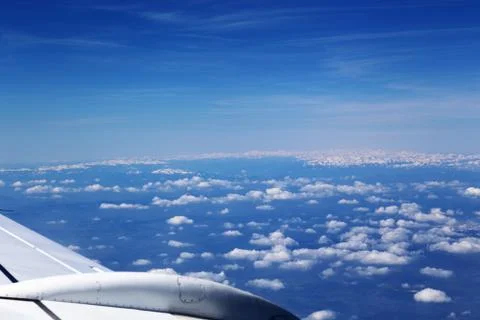 View from window of a jet plane wing with beautiful weather Stock Photos
