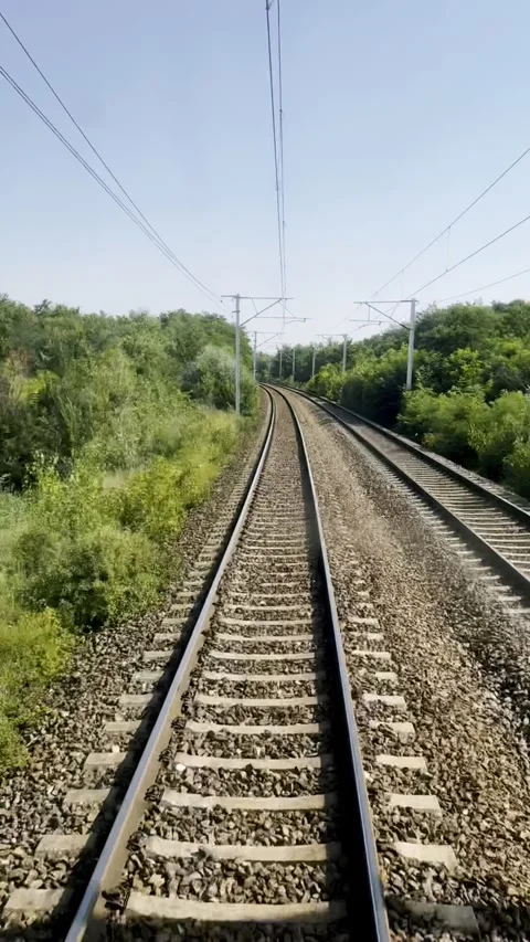 A view from the window of the last train car onto a railway Stock Footage 337996065