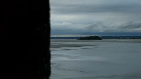 View from the window of a medieval fort. Mont Saint Michel bay during low tide Video stock 323918987