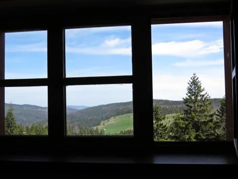 View from Window at Mountains, Forrest and Sky with Clouds Stock Photos