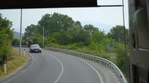 View from the window of a moving bus on the scenery of a village Stock Footage 194328503