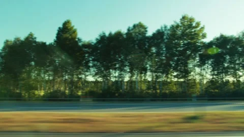 View from window of moving car capturing summer countryside landscape with blur Stock-Footage 335762455