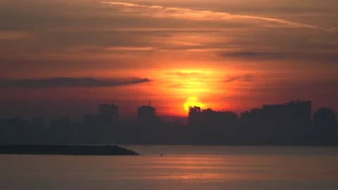 View from window of moving car at dramatic sunset over city and large Stock Footage 228668007