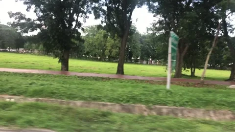 View from window of moving car. Motorcycle scooter passes by. Stock Footage 246059139