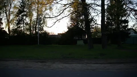 View from the window of a moving car to a village against the backdrop of the Stockbeeldmateriaal 311648398