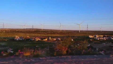 View from the window of a moving car to the windmills. Stock Footage 297551252