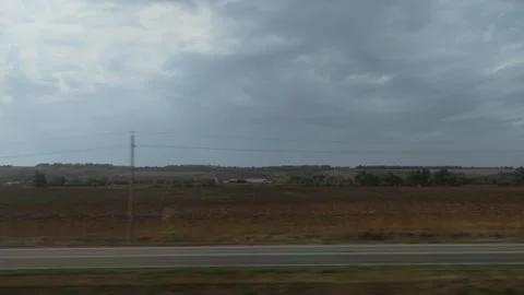 View from the window of a moving train against the backdrop of nature, fields Stock Footage 315513847