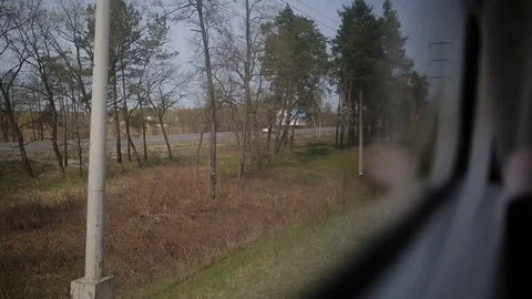 View from the window of moving train. Green nature, sunny day in the view. Stock Footage 81267056