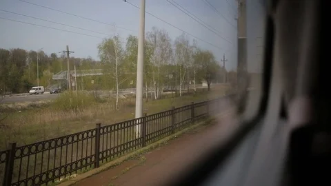 View from the window of moving train. Green nature, sunny day in the view. Stock Footage 81267143