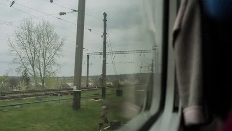 View from the window of moving train. Green nature, sunny day in the view. Stock Footage 81356823