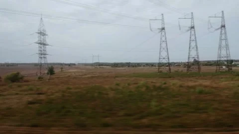 View from the window of a moving train of nature, landscapes, power lines and Stock Footage 314888791