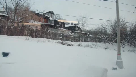 View from the window of a moving train in the suburbs of a Siberian city with Stock Footage 195104391
