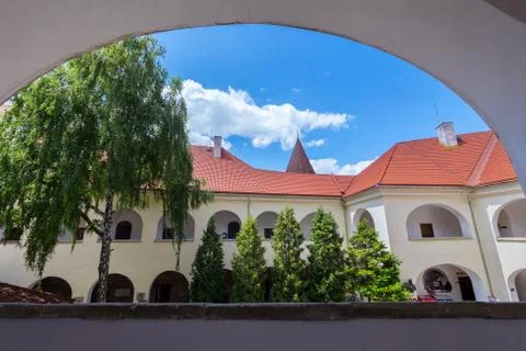 View from the window to the nearest building of an old castle with a red roof Foto stock