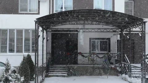 View from the window to the neighboring house and falling snow Stock Footage 167754417