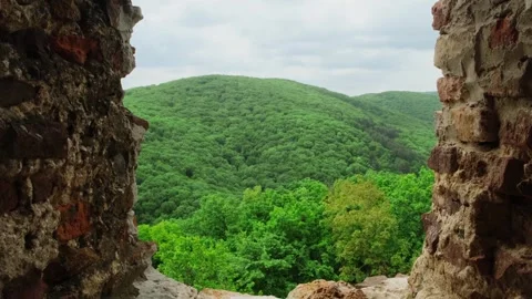 View from the window of the old brick fortress on the mountain landscape. Stockbeeldmateriaal 249134873
