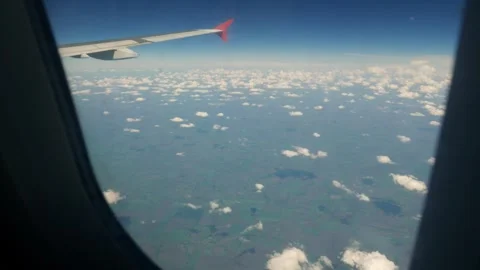 View from the window of a passenger airliner plane. Lots of small cumulus clouds 스톡 동영상 305596524