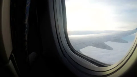 A view from the window of a passenger airplane flying low over the clouds in bad Stock Footage 86008128