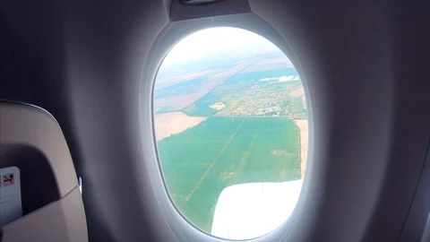 View from the window of a passenger airplane of a landscape Stock Footage 116257866