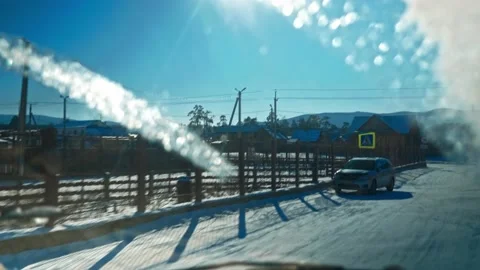 View from the window of a passing car of a provincial Russian winter village in Stock Footage 228883317