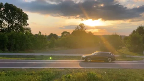 View from the window of a passing train to a village, rural landscape and cars. Stock Footage 318977609