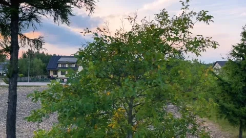 View from the window of a passing train of a village and rural landscape. Video stock 318977667