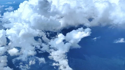 View from window of plane. Aircraft flies into a cluster of beautiful clouds. Stock Footage 282892112