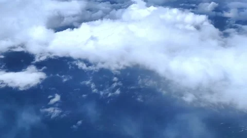 View from window of plane. Aircraft flies into a cluster of beautiful clouds. Видео 283268352