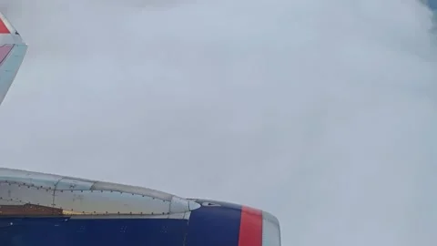 View from window of plane. Aircraft flies into a cluster of beautiful clouds. Stock Footage 283902592