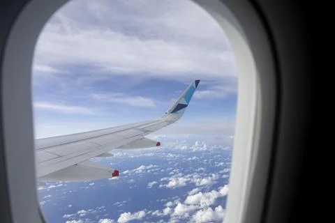 View from the window of a plane. Airplane wing out of window. Stock Photos