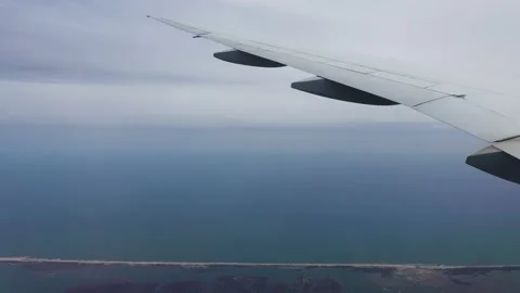 View from a window plane on Atlantic Ocean and coastal cities Stock Footage 194353437