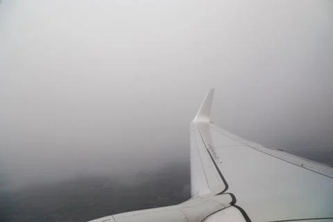 View from the window of the plane in bad non-flying weather. Turbulence in Stock Photos