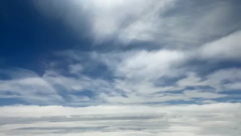 View from the window of the plane to the blue sky and white clouds Stock Footage 213165544