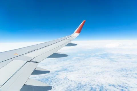 View from the window of the plane on the blue sky, in good weather. Stock-Fotos